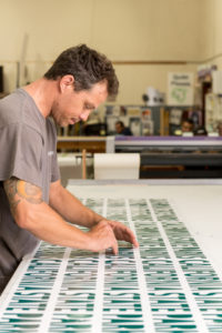sign technologies employee working on vinyl lettering