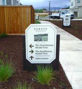 Directional sign on property to direct foot-traffic to sales office.
