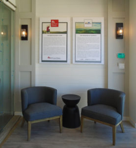 The Meadow's Interior, composing of 2 chairs an end table, 2 framed artwork and 2 accent lights.