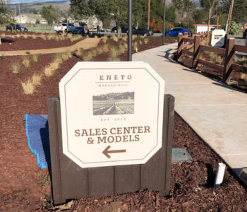 Outdoor Sales Center & Models sign directing foot traffic to sales office.