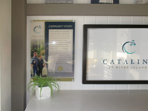 Cross section view of Catalina's interior sales office's TV wall. Showing digital print on acrylic of community story.
