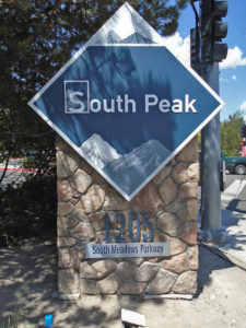 Diamond shaped sign identifying the South Peak Apartment complex.