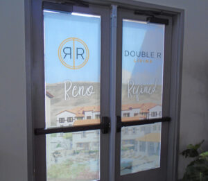 Double Glass door with decal of Double R branding stretched across both doors.