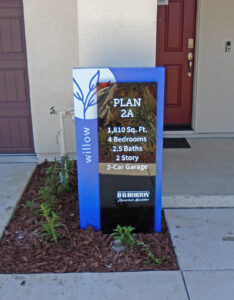 Large Portrait box sign installed outside home to ID its square footage, bedrooms & bathrooms.