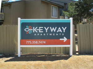 Sign with arrow to give direction in apartment complex.