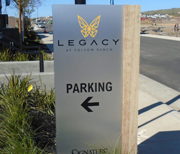 Rectangular box sign with Parking on face and arrow.