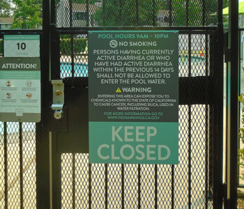Sign installed on entrance of pool warning of person(s) with active diarrhea to not enter.
