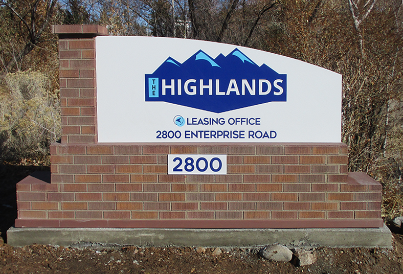 The Highlands Monument sign located on the corner.