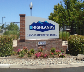 Large Outdoor Monument with Logo located at the entrance gate.