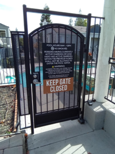 Keep Gate CLosed sign installed on metal gate.