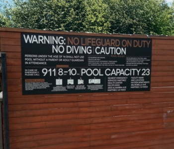 Large pool sign installed on wood wall.