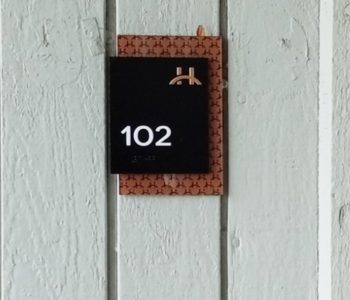 Sign installed on building of room 102.